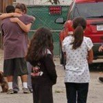 jacobb Family and friends gather to console one another by the spot where Jacob Benavidez, 15, lost his life to multiple gunshot wounds suffered in a drive by in the 1100 block of E. 16th Street in Long Beach early on Tuesday. (Diandra Jay/Staff Photographer)