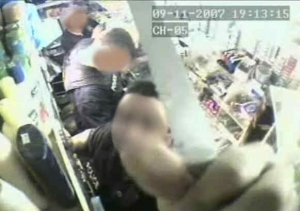phillyg2drug30c Philly police officer cutting wire to camera before they rob store.