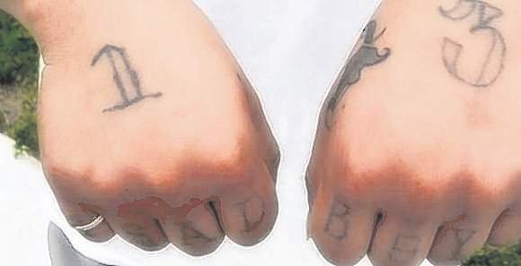 A number “13″ tattooed on the hands signified membership of street gang Sur 