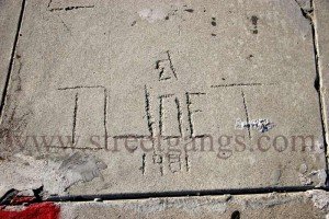 Dog Town pavement graffiti in the sidewalk at Bolero & Leroy in the William Mead Housing projects, 2012